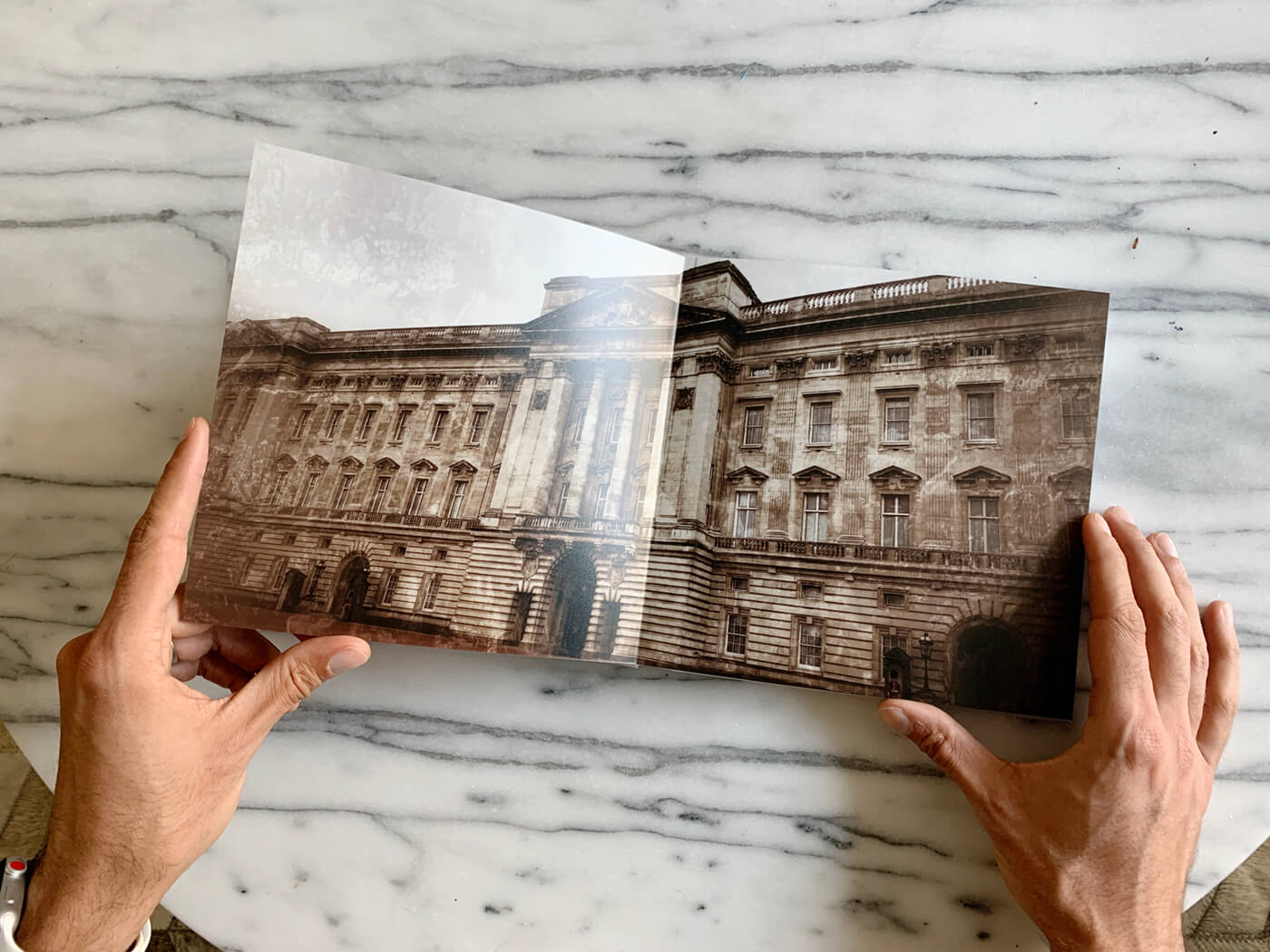 person looking at a photo book by printique