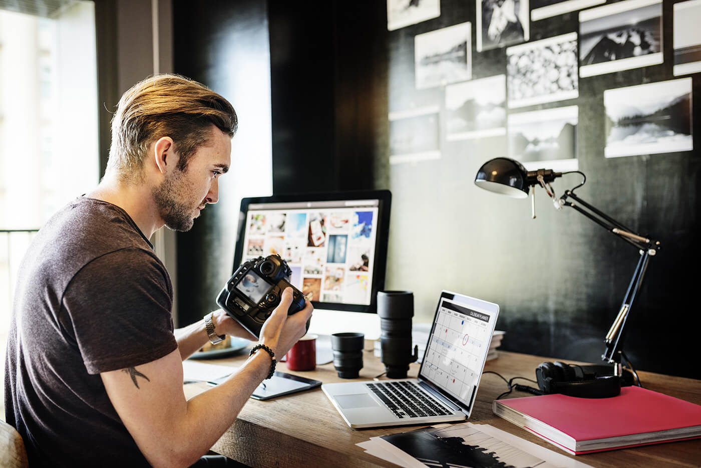 photographer at desk checking camera