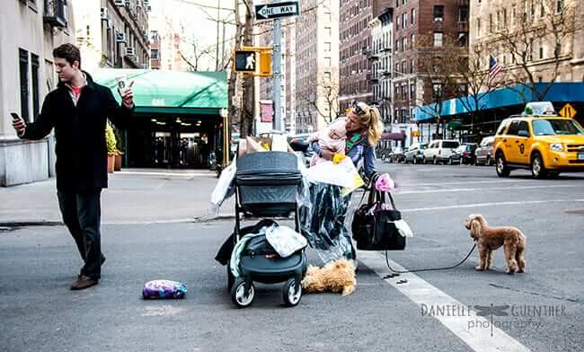 Young family in street mom with hands full