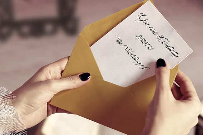 woman holding wedding invitation