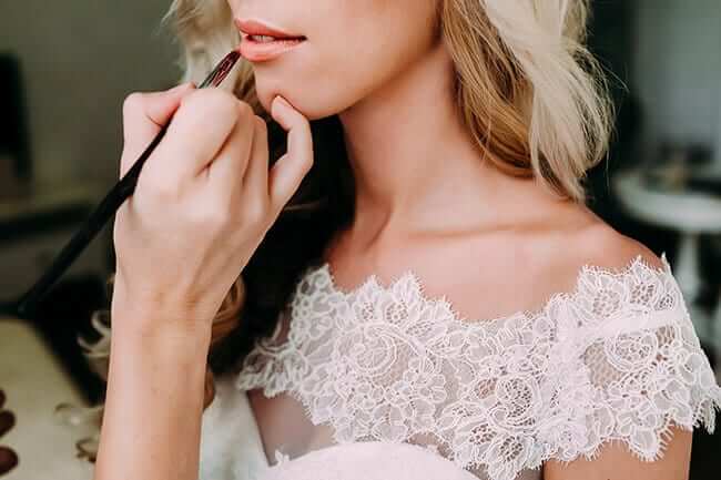 bride getting lipstick touched up