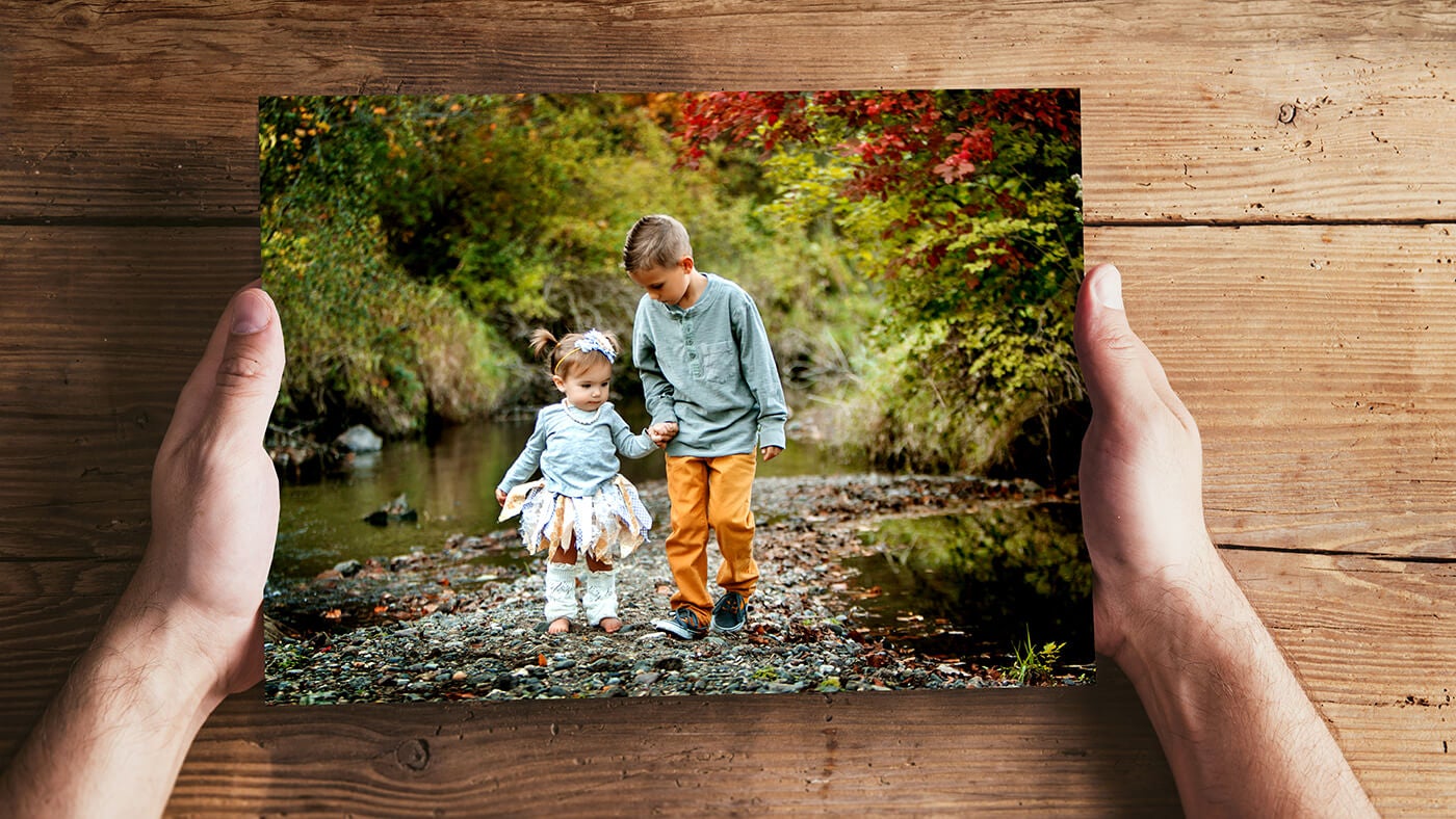 man holding photo of children printed by printique