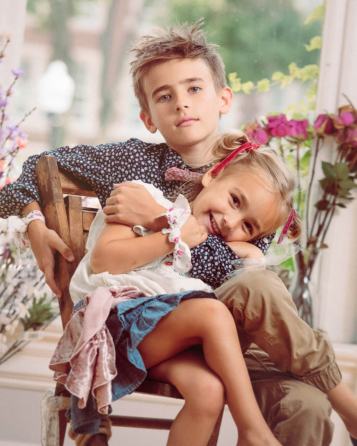 brother sister hugging in chair