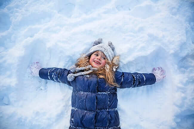 kid making snow angel